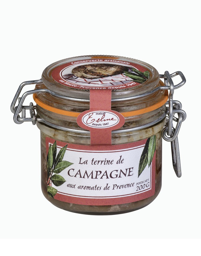 Terrine de Campagne aux Aromates de Provence de la Maison Telme, présentée dans un pot en verre avec une étiquette rouge. L'étiquette met en avant des feuilles de laurier, évoquant le goût authentique et rustique de cette spécialité artisanale parfumée aux herbes de Provence.